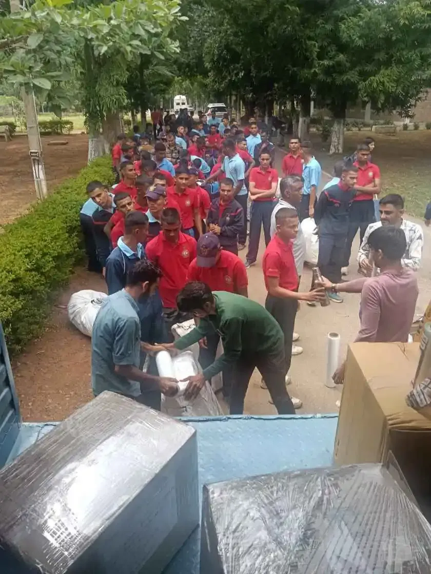 Wrapped furniture and cartons with people outdoors