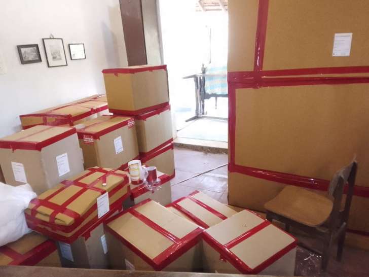 Real on-site household packaging and staging in Chennai for Tirupur relocation showing 5-ply corrugated boxes, heavy red tape sealing, and inventory barcode tags