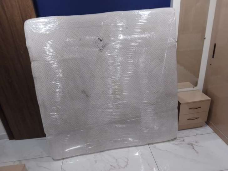 Movers and packers wrapping king size mattress with heavy-duty stretch film for Chennai to Cuddalore shifting